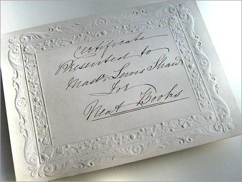 Image of embossed bordered card with hand writing